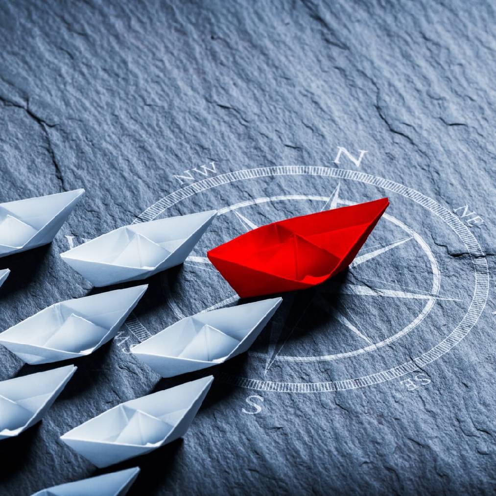 Red Paper Boat On Compass Leading A Fleet Of Small White Boats - Business Leadership Concept; Shutterstock ID 2181758227; NP: GOV/INDIGO